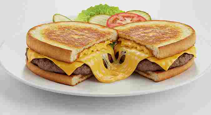 Grilled Cheese Burger with melted cheese and toasted golden bun.